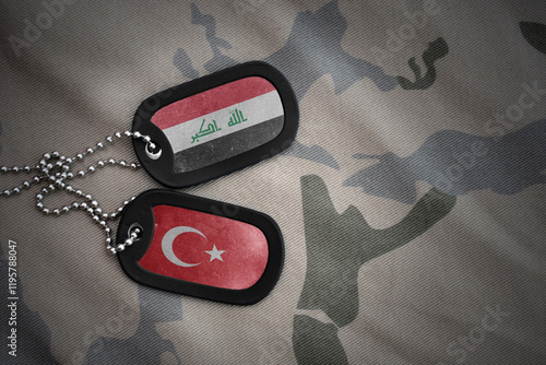 vintage army blank, dog tag with flag of iraq and turkey on the khaki texture background. military concept. photo