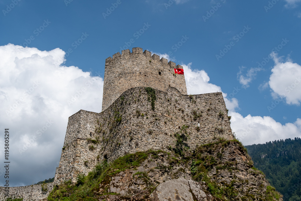 Historical castle tower with a Turkish flag against a clear blue sky, showcasing ancient stone walls and cultural heritage. Zilkale, Camlihemsin, Rize, Turkey Historical castle tower with a Turkish flag against a clear blue sky, showcasing ancient stone walls and cultural heritage. Zilkale, Camlihemsin, Rize, Turkey