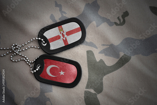 vintage army blank, dog tag with flag of northern ireland and turkey on the khaki texture background. military concept. photo