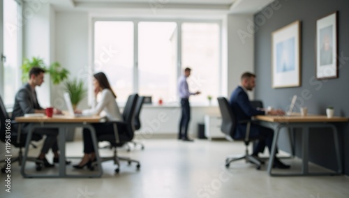 Modern abstract office space with busy workers background focusing on empty foreground for text or other design elements