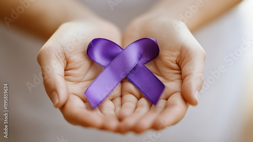 Wallpaper Mural A close-up of hands gently holding a purple ribbon, symbolizing support and awareness Torontodigital.ca