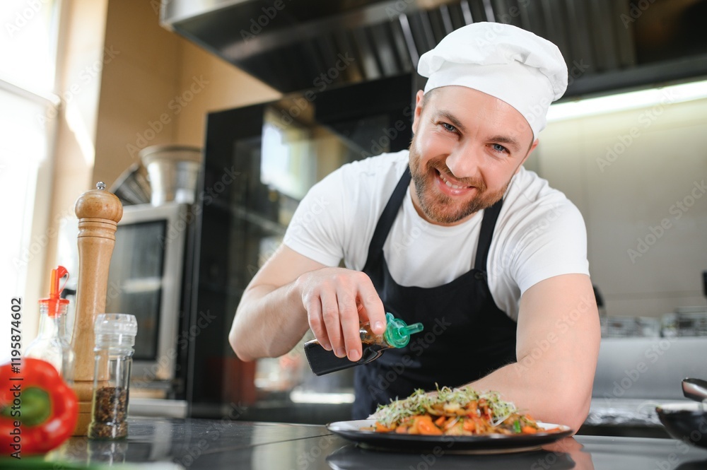 Portrait of happy caucasian male chef standing in restaurant kitchen, copy space Portrait of happy caucasian male chef standing in restaurant kitchen, copy space
