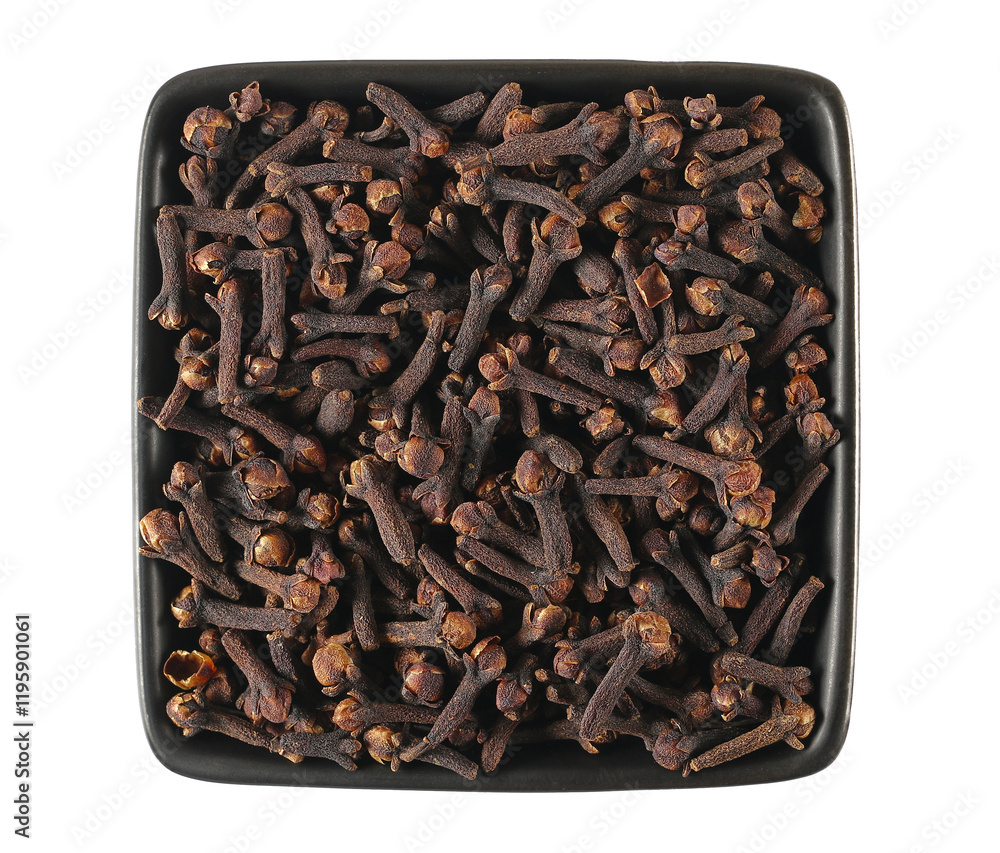 Dry cloves pile in bowl, Syzygium aromaticum, isolated on white, top view Dry cloves pile in bowl, Syzygium aromaticum, isolated on white, top view