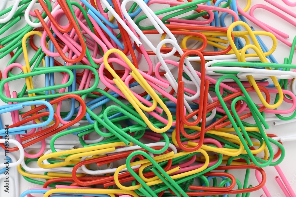 Colorful paper clips on light background, top view Colorful paper clips on light background, top view
