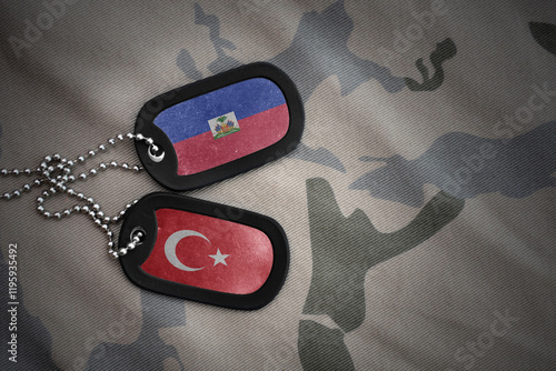 Photography vintage army blank, dog tag with flag of haiti and turkey on the khaki texture background
