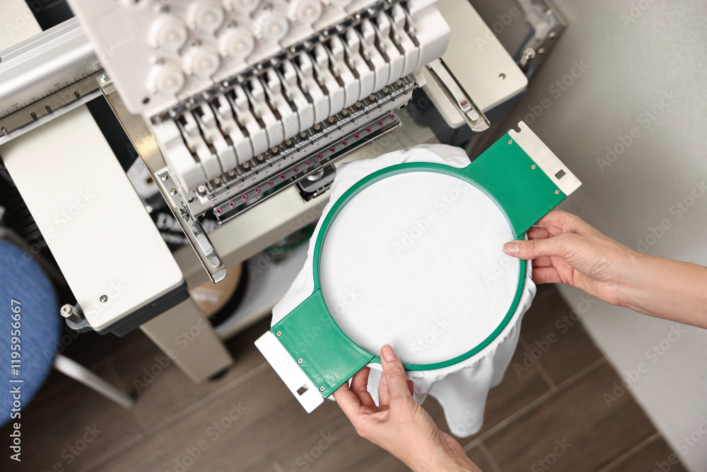 Φωτογραφία Woman using embroidery machine to make design on T-shirt indoors, closeup