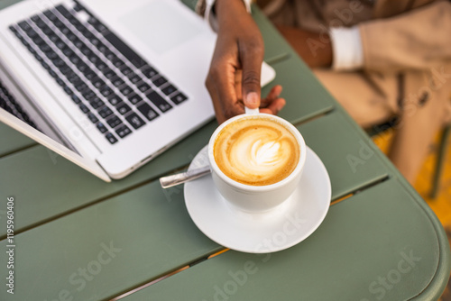 Black Woman Enjoying Coffee Break with Laptop Outdoors