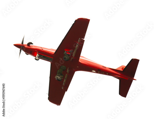 Fotografía Red single engine low wing aircraft flying isolated on white background