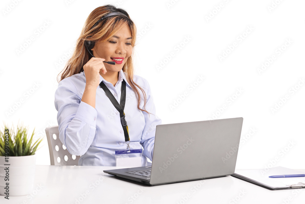 Asian female working with a hands free mic and a laptop computer Asian female working with a hands free mic and a laptop computer