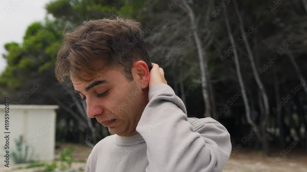 Boy Makes Intimidated And Ashamed Expression In Nature In A Park Boy Makes Intimidated And Ashamed Expression In Nature In A Park
