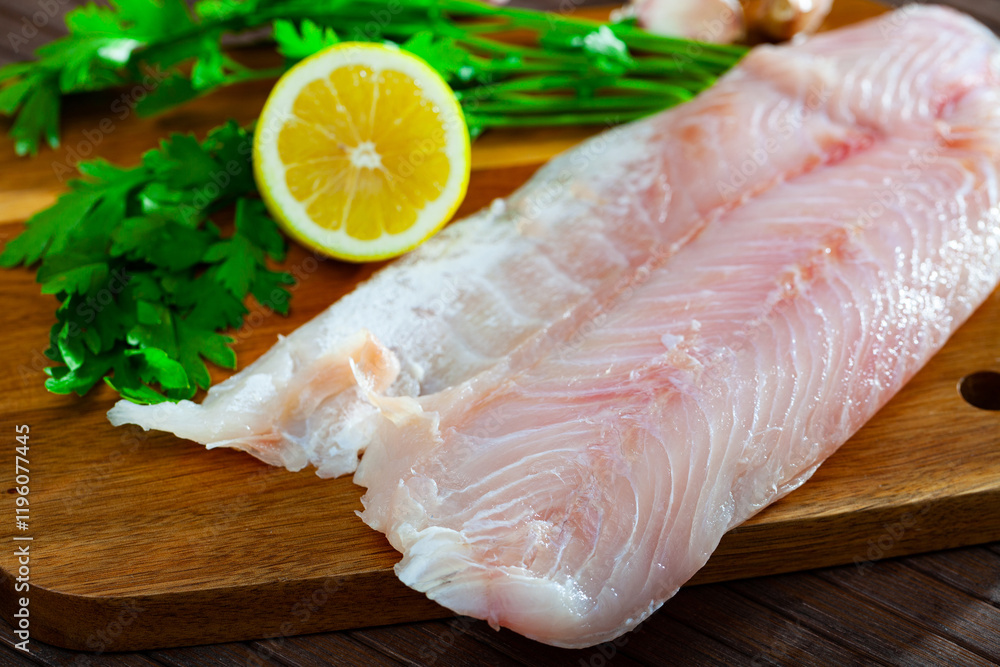 Raw seafood, fresh perch fillet on wooden board Raw seafood, fresh perch fillet on wooden board