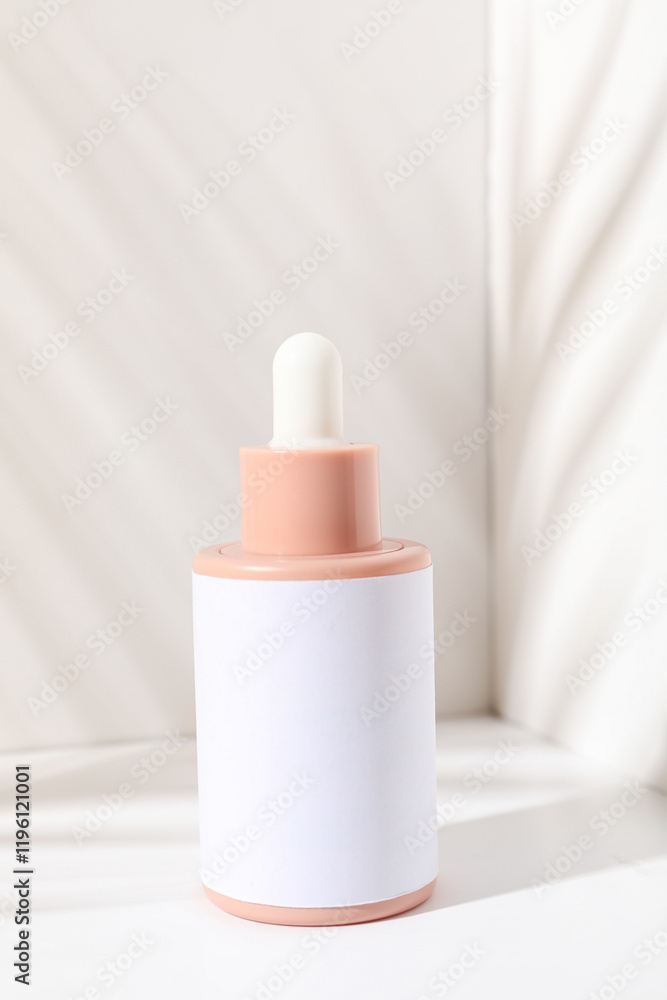 Cosmetic oil in a bottle on a light background Cosmetic oil in a bottle on a light background