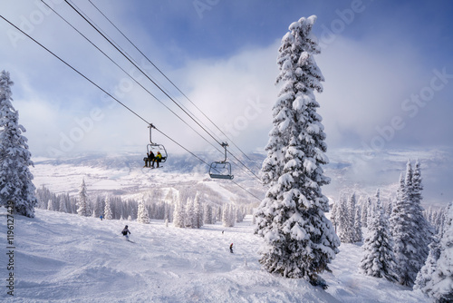 Chairlift with snow covered pine tree at Steamboat Colorado