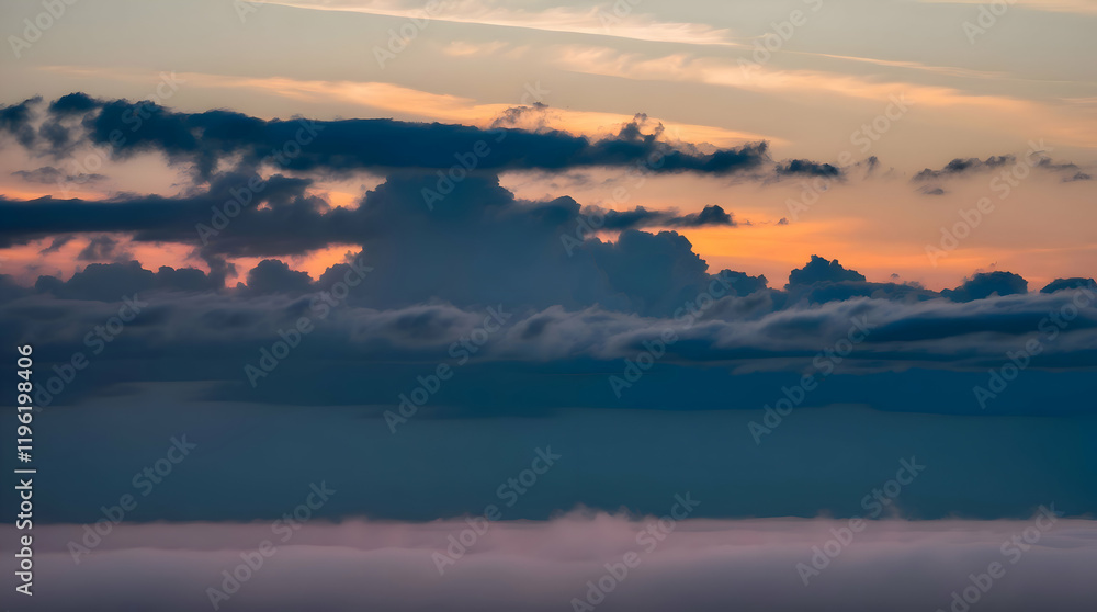Dramatic sunset cloudscape over a misty horizon.