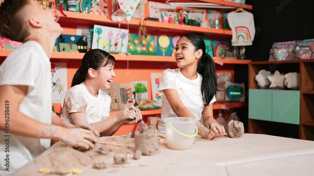 Caucasian high school girl modeling cup of clay while looking smart boy in art class at workshop. Multicultural student playing or making cup of clay art in creative activity. Education. Edification Caucasian high school girl modeling cup of clay while looking smart boy in art class at workshop. Multicultural student playing or making cup of clay art in creative activity. Education. Edification