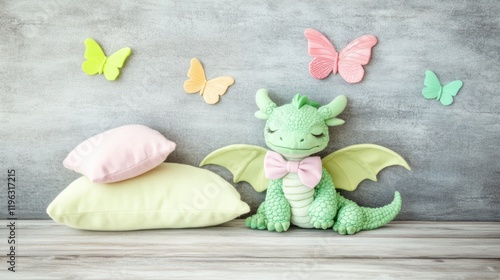 Cute, pastel green dragon figurine with soft pastel pillows and butterflies on a gray wall. photo