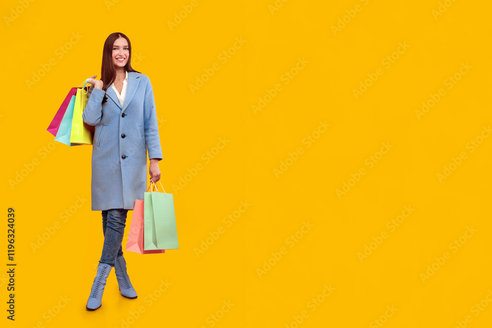 Seasonal Sales. Vertical portrait of girl posing with her purchases, isolated on pastel pink studio wall Seasonal Sales. Vertical portrait of girl posing with her purchases, isolated on pastel pink studio wall