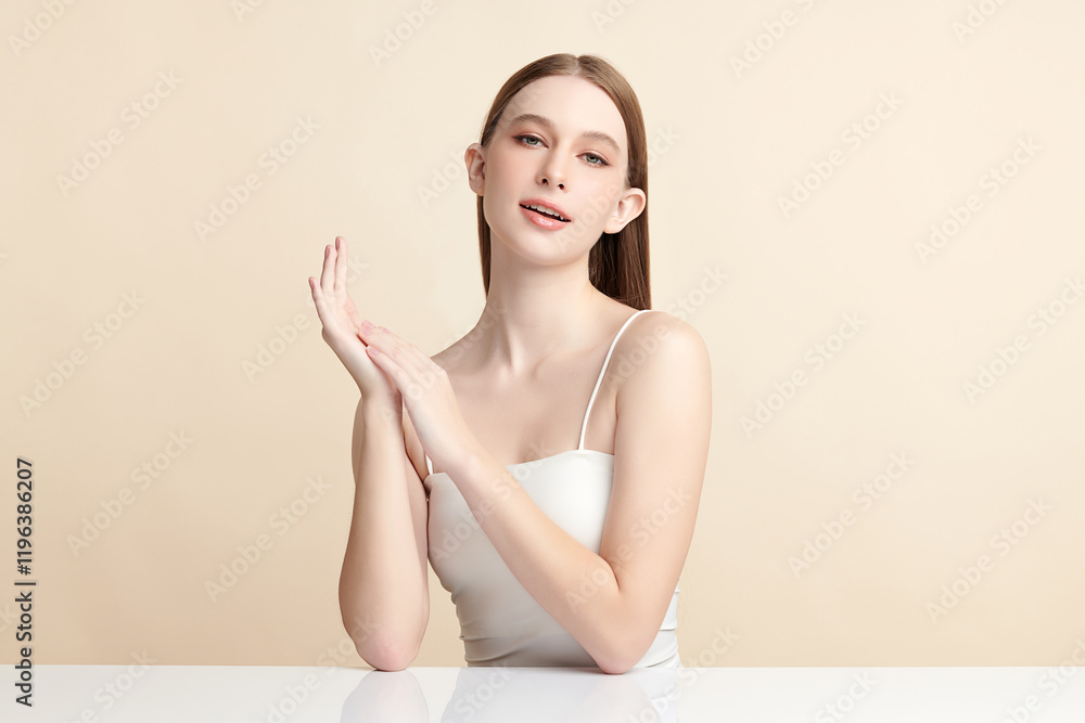 Beautiful young woman with clean fresh skin on beige background, Face care, Facial treatment, Cosmetology, beauty and spa, women portrait.