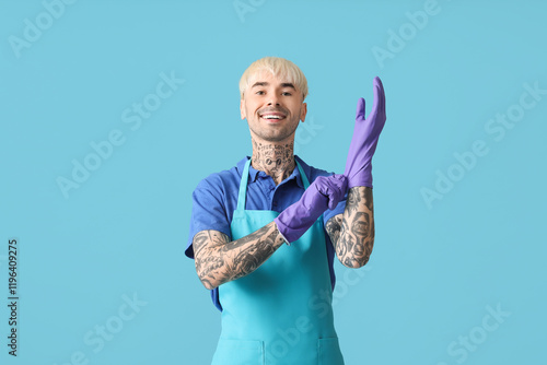 Young tattooed man putting ...