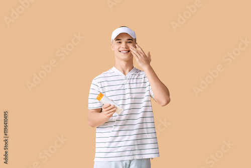 Happy young man applying su...