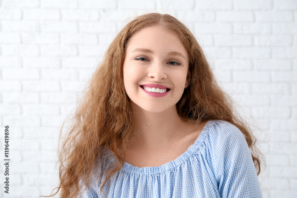 Portrait of happy redhead woman near white brick wall Portrait of happy redhead woman near white brick wall