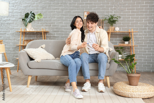 Happy young couple with pre...