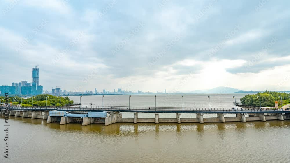 Time lapse of Shenzhen Bay showcasing blue sky, white clouds, and vibrant urban scenery Time lapse of Shenzhen Bay showcasing blue sky, white clouds, and vibrant urban scenery