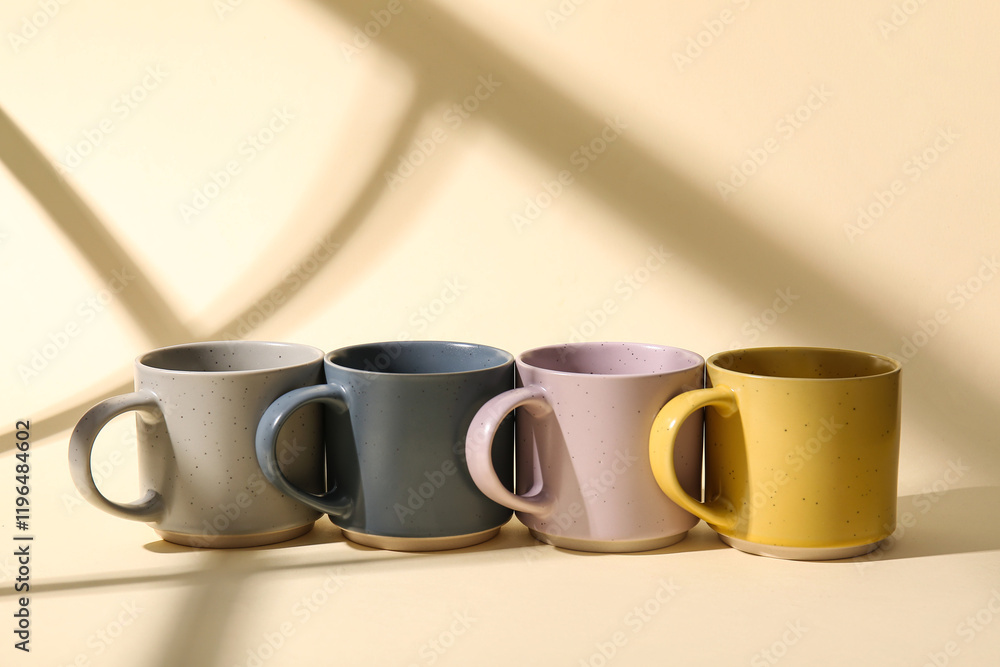 Set of stylish ceramic mugs on color background Set of stylish ceramic mugs on color background