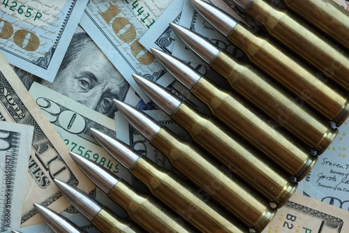 Obraz na plátně Yellow cartridges and bullets on dollar bills