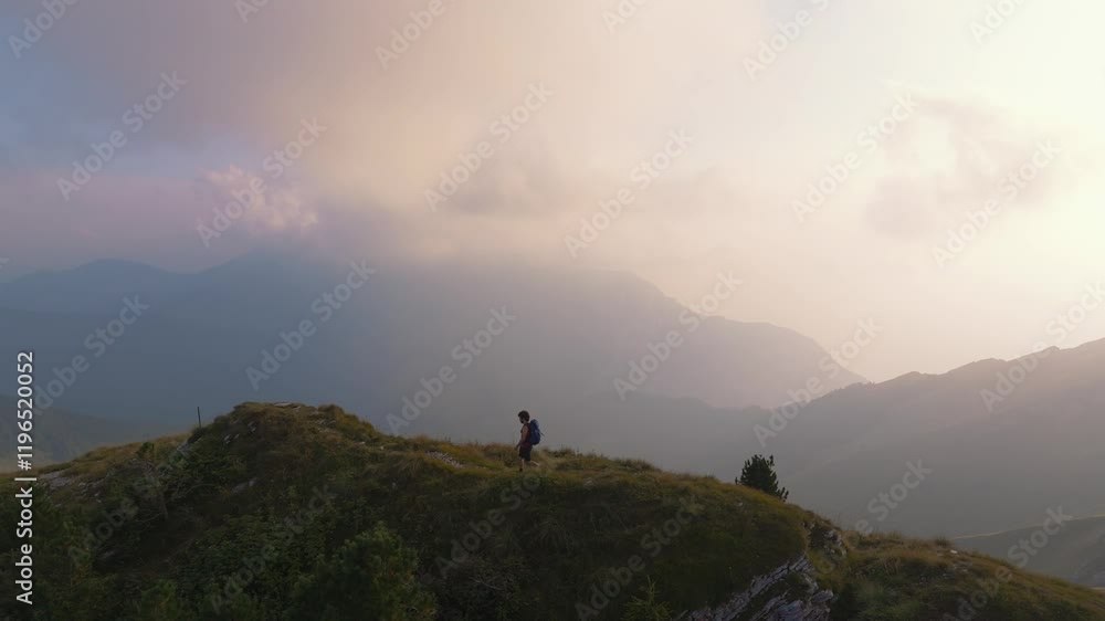 Young man hiking in scenic Italian alps mountains on panoramic Monte Baldo near Lake Garda, Verona Young man hiking in scenic Italian alps mountains on panoramic Monte Baldo near Lake Garda, Verona