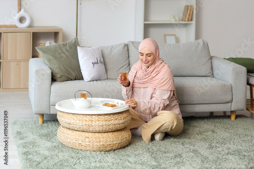 Young Muslim woman with gla...