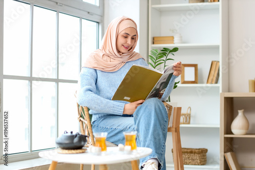 Young Muslim woman reading ...
