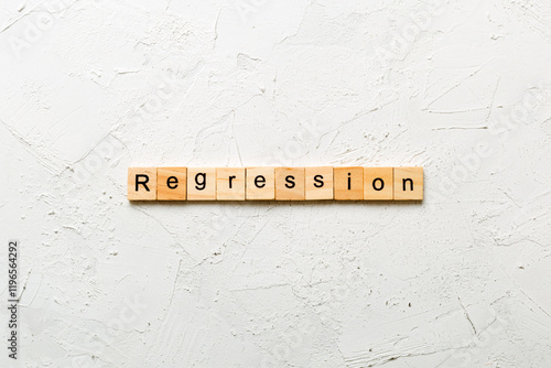 regression word written on wood block. regression text on cement table for your desing, concept photo