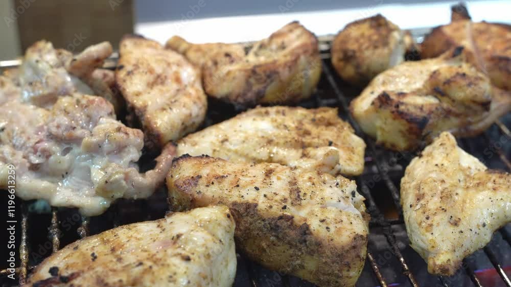 Close-up of chicken meat cooking on a gas grill. Delicious meat. Close-up of chicken meat cooking on a gas grill. Delicious meat.