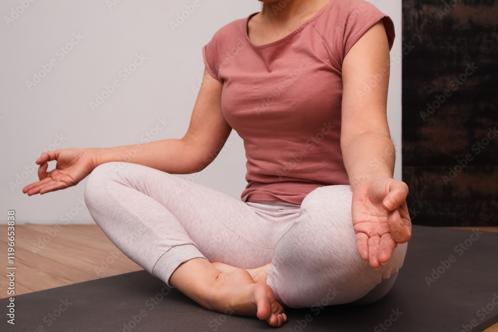 Woman practicing breathing exercise. Hand, lotus pose. Woman on a floor for yoga, mediation and zen. Woman Practicing Yoga Indoors. Woman practicing breathing exercise. Hand, lotus pose. Woman on a floor for yoga, mediation and zen. Woman Practicing Yoga Indoors.