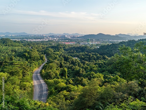 Winding road through lush green hills overlooking a city at sunset; travel, nature background photo