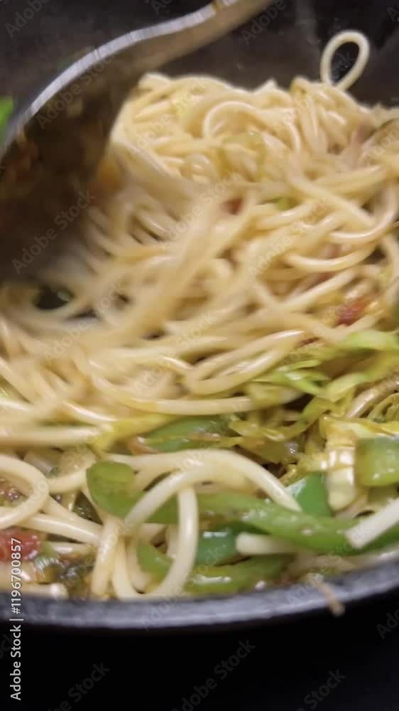 stir fried noodles with vegetables making in a pan. stir fried noodles with vegetables making in a pan.