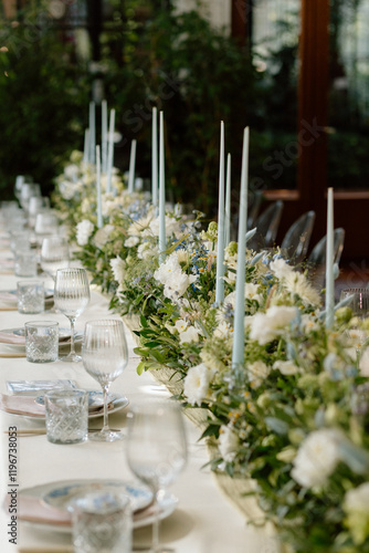 Modern stylish wedding table setting. The wedding decor. The pastel colors flowers bouquet. Natural beautiful wedding decorations. Minimalistic wedding decorations