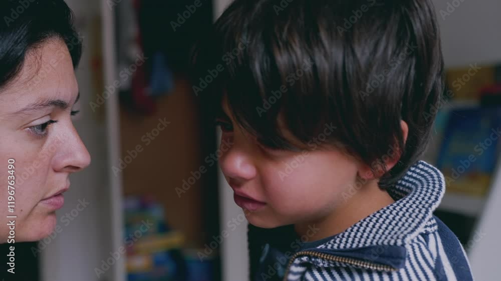 Mother and child in an emotional moment indoors, with the child displaying a sad expression while the mother looks on. tender and supportive interaction between parent and child Mother and child in an emotional moment indoors, with the child displaying a sad expression while the mother looks on. tender and supportive interaction between parent and child