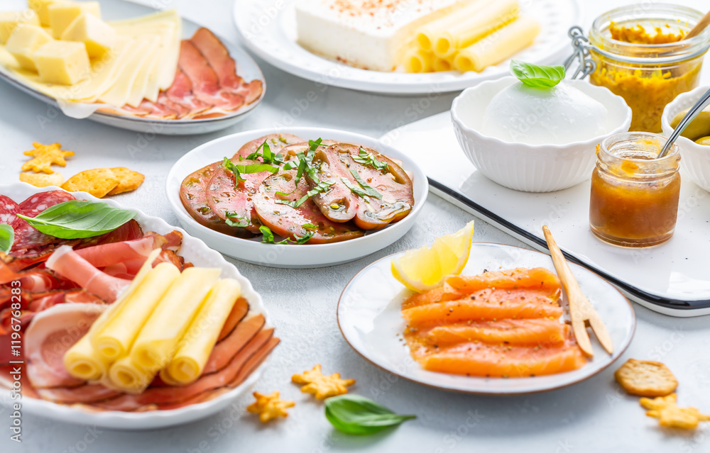 Assorted appetizers for brunch or party with salmon, cheese, salami and vegetables Assorted appetizers for brunch or party with salmon, cheese, salami and vegetables