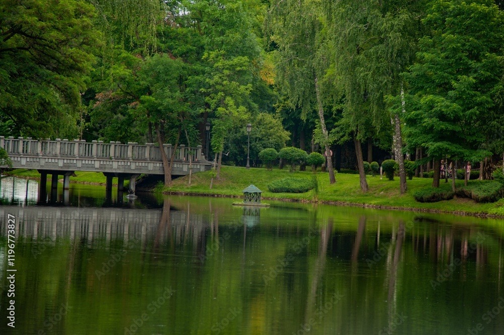 Serene park scene with bridge and pond Serene park scene with bridge and pond