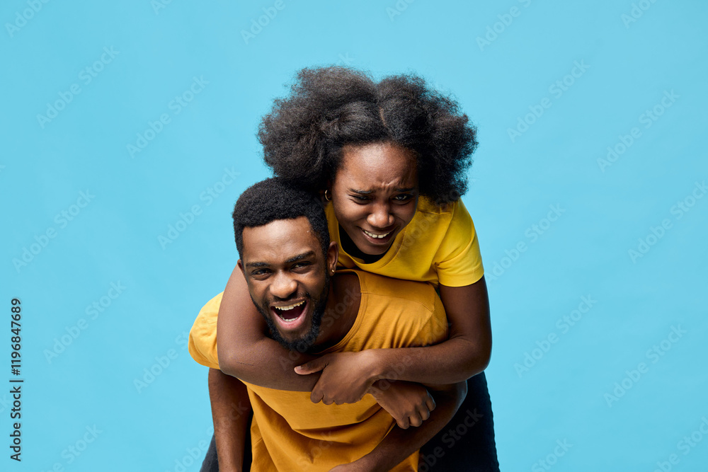 Happy couple laughing together against a bright blue background, showcasing joy and love, perfect for seasonal celebrations or romantic themes Happy couple laughing together against a bright blue background, showcasing joy and love, perfect for seasonal celebrations or romantic themes