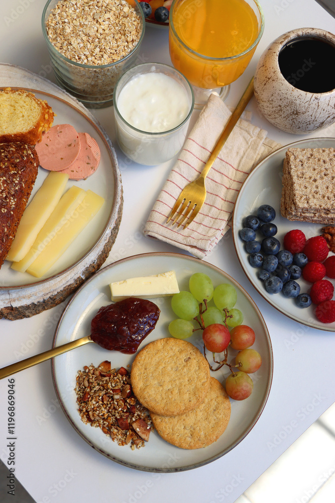 Assortment of various breakfast foods and drinks on the white table. Selective focus.