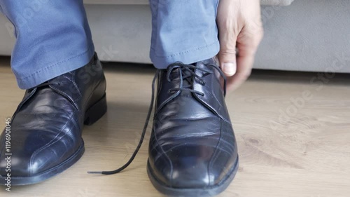 Close-up of man touching feet with his hand at office