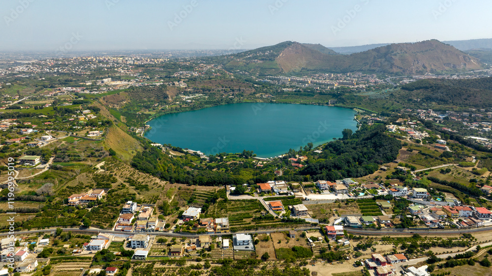 Obraz premium Aerial view of Lake Avernus (Lago d'Averno) located Pozzuoli, near Naples, in Campania, Italy. It is a volcanic crater lake located in Phlegraean Fields (Campi Flegrei). The lake is roughly circular.