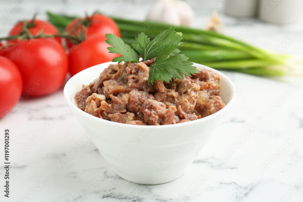 Canned meat in bowl, parsley, tomatoes and green onions on white marble table, closeup Canned meat in bowl, parsley, tomatoes and green onions on white marble table, closeup