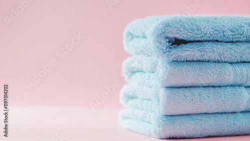 Pile of fresh cotton towels, spa sauna beauty health concept on soft calm pink background
