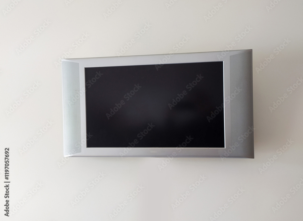 Sleek silver flatscreen TV mounted on a plain white wall. Perfect for showcasing technology, home d?cor, or minimalist design concepts. Ideal for websites, brochures, or presentations. Sleek silver flatscreen TV mounted on a plain white wall. Perfect for showcasing technology, home d?cor, or minimalist design concepts. Ideal for websites, brochures, or presentations.