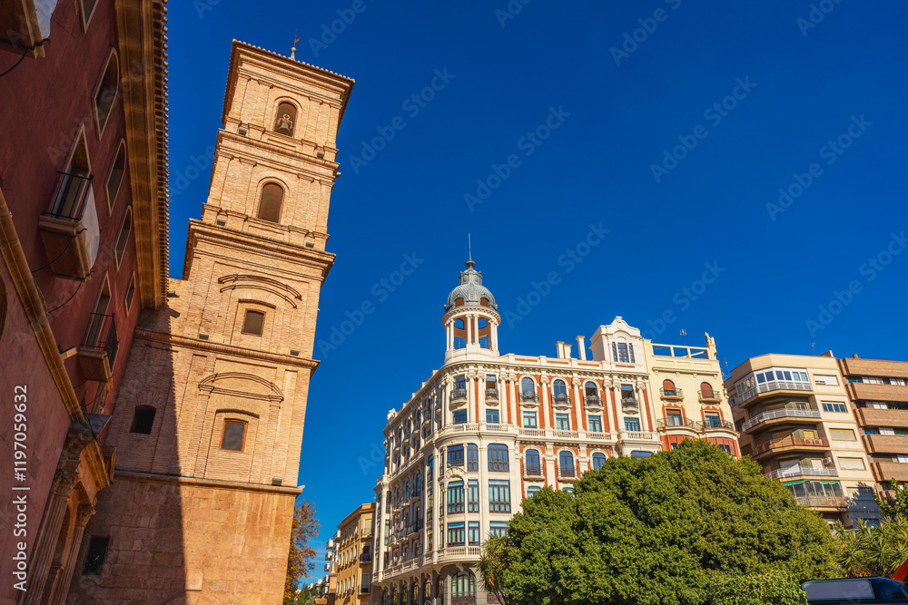 Fototapeta premium Several buildings such a church and residential conform a generic cityscape in Murcia City, Spain