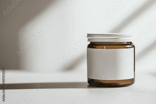 Elegant glass jar on minimalist surface casts soft shadows, invi photo